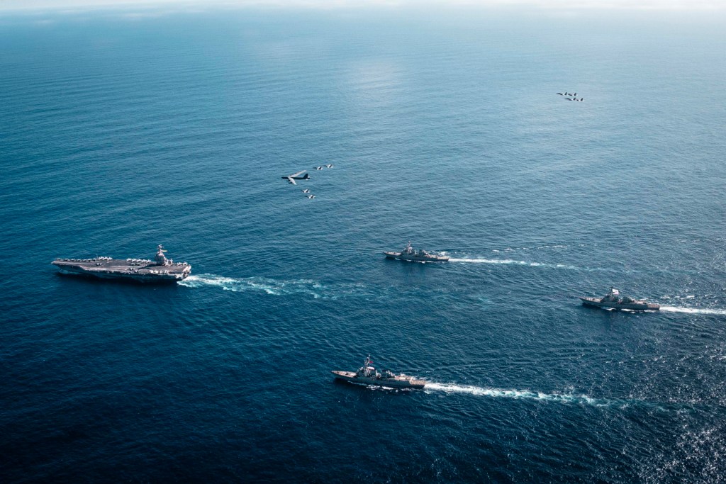 The U.S. Navy’s Gerald R. Ford Carrier Strike Group, including the flagship USS Gerald R. Ford (CVN 78), left, USS Winston S. Churchill (DDG 81), front, USS Mahan (DDG 72), back, USS Bainbridge (DDG 96), and embarked Carrier Air Wing Eight F/A-18E/F Super Hornets assigned to Strike Fighter Squadrons 31, 37, 87, and 213, operates as a joint, multi-domain force with a U.S. Air Force B-52 Stratofortress, Nov. 13, 2025; transiting the Anegada Passage and entered the Caribbean Sea, Nov. 16, 2025