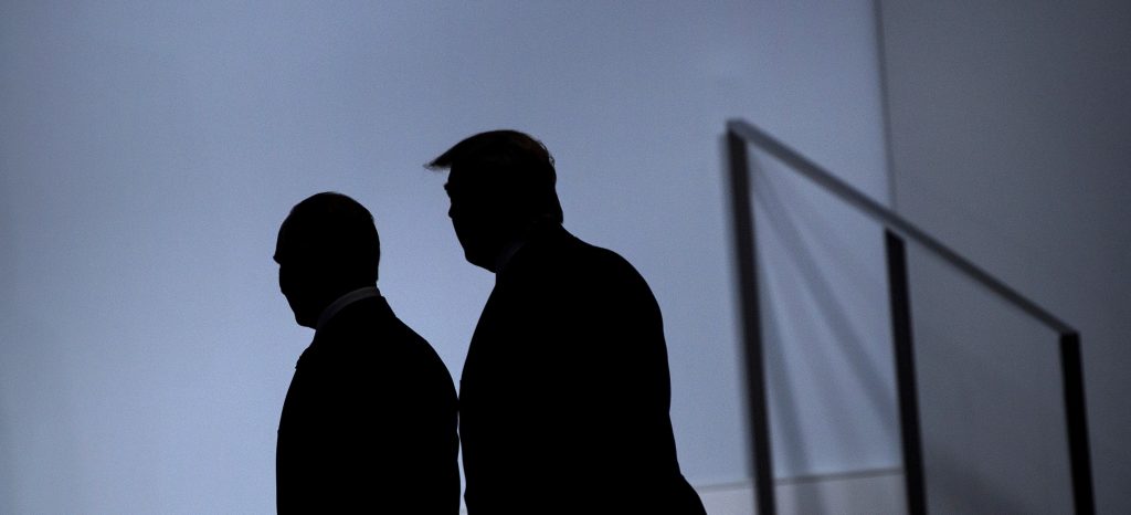 Trump and Putin’s silhouettes as they walk side-by-side.