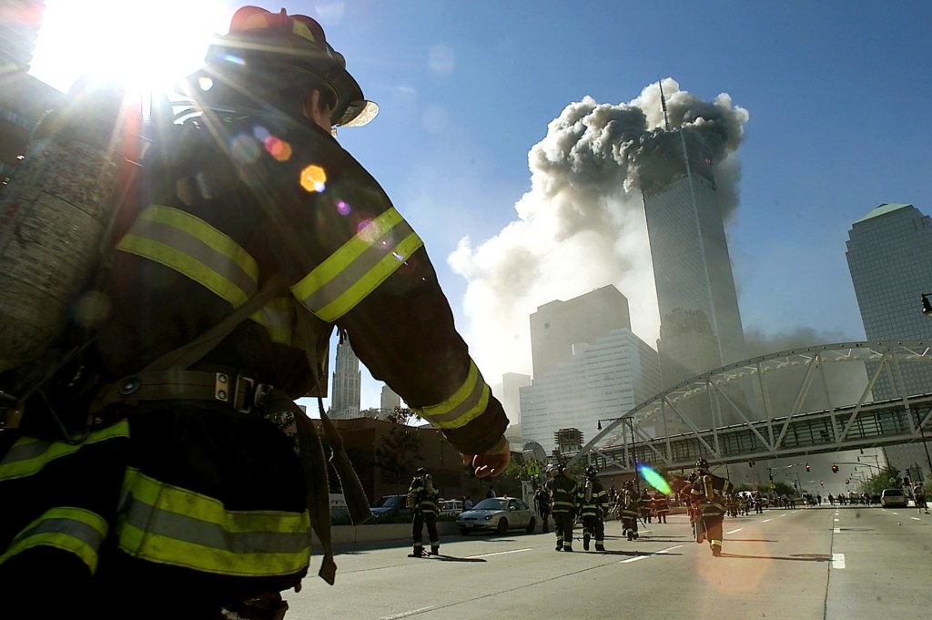 Firefighters walk towards one of the tower at the World Trade Center before it collapsed after a plane hit the building September 11, 2001 in New York City. (Photo by Jose Jimenez/Primera Hora/Getty Images)