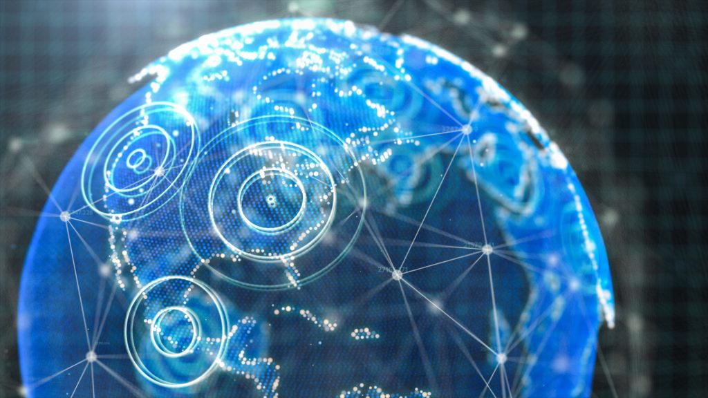 A 3D hologram of the globe with circles and grids laid over to indicate communications and technology.