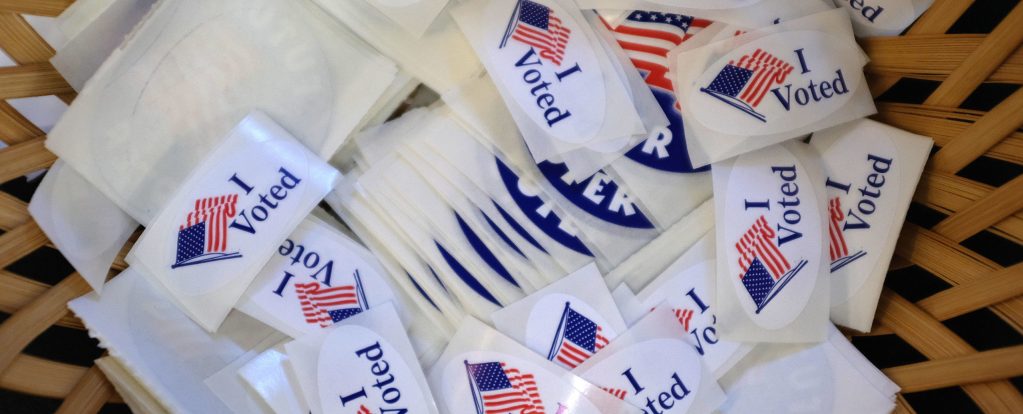 Pile of stickers with text "I Voted" and US flag image