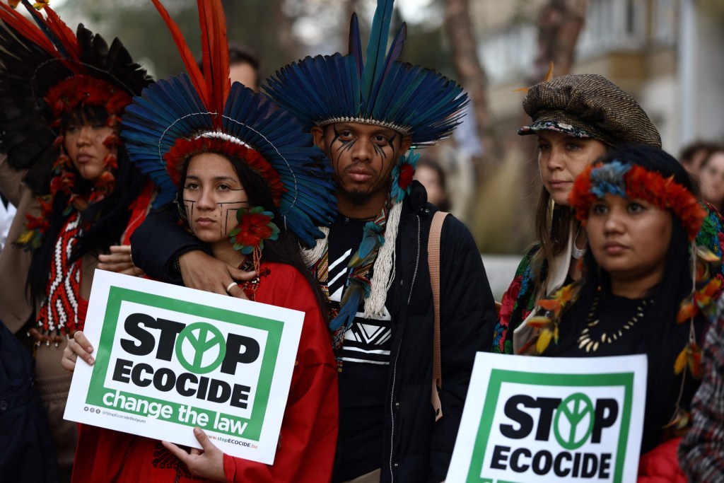 Brazilian indigenous people and others take part in a demonstration called by Stop Ecocide International (SEI) for the recognition of ecocide as an international crime, on October 20, 2022 outside the European Council in Brussels where EU leaders were gathered for a summit. (Photo by KENZO TRIBOUILLARD/AFP via Getty Images)