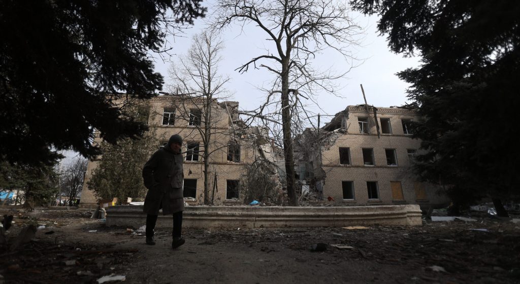 A person walks past a hospital destroyed by a Russian missile attack in the town of Selydove, Donetsk region