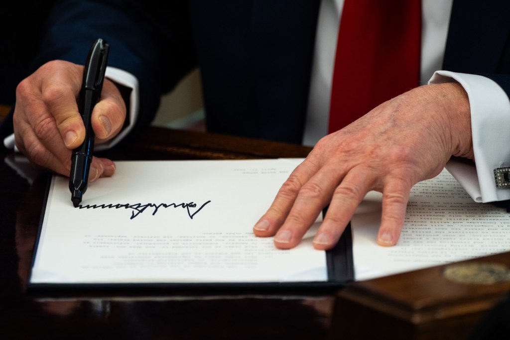 U.S. President Donald Trump signs an Executive Orde
