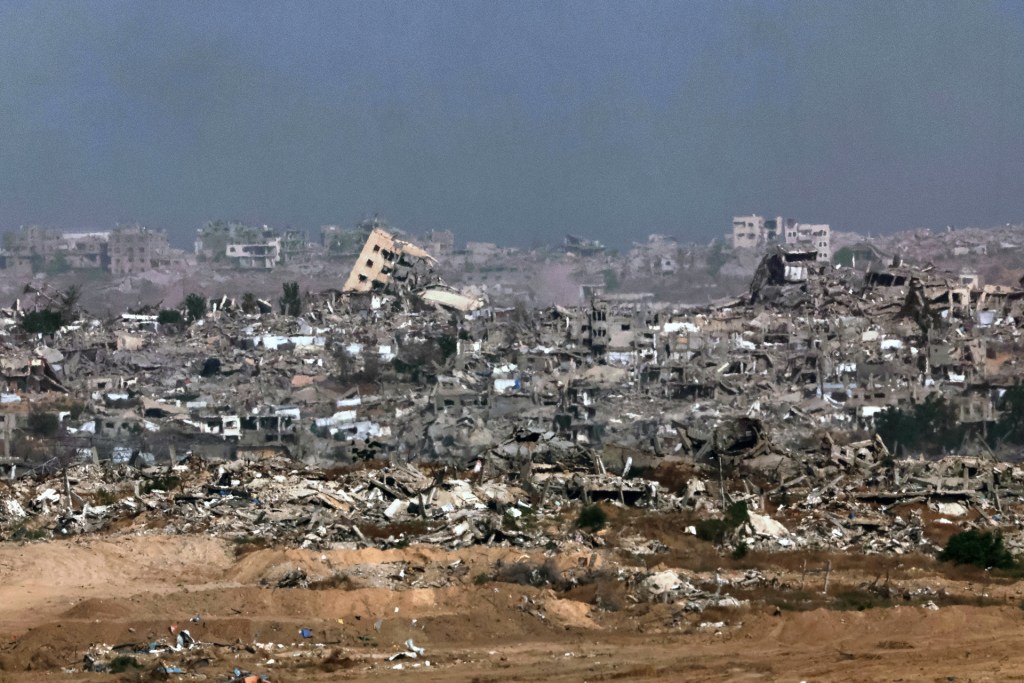 This picture taken from a position in southern Israel, on the border with the Gaza Strip, shows destroyed buildings in the besieged territory on May 27, 2025. (Photo by JACK GUEZ/AFP via Getty Images) 