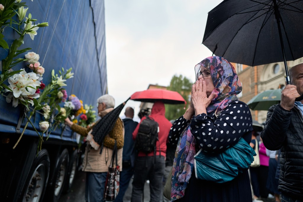Families and local residents pay their respects, offer prayers, and attach flowers to a truck carrying the coffins of seven newly identified victims of the Srebrenica genocide, as it departs for the Srebrenica-Potocari Memorial Center on July 9, 2025 in Sarajevo, Bosnia and Herzegovina. 2025 marks the 30th anniversary of the end of the Bosnian War, and July 11th is the anniversary of the Srebrenica Massacre. On that day in 1995, Bosnian Serb forces captured the eastern Bosnian town of Srebrenica, then a U.N.-protected enclave. They began killing over 8,000 Muslim men and boys (Bosniaks) in what became known as the Srebrenica Massacre. The bodies were found in mass graves after the war had ended, and in 2004, the International Criminal Tribunal for the former Yugoslavia (ICTY) defined the killings as genocide. (Photo by Pierre Crom/Getty Images)
