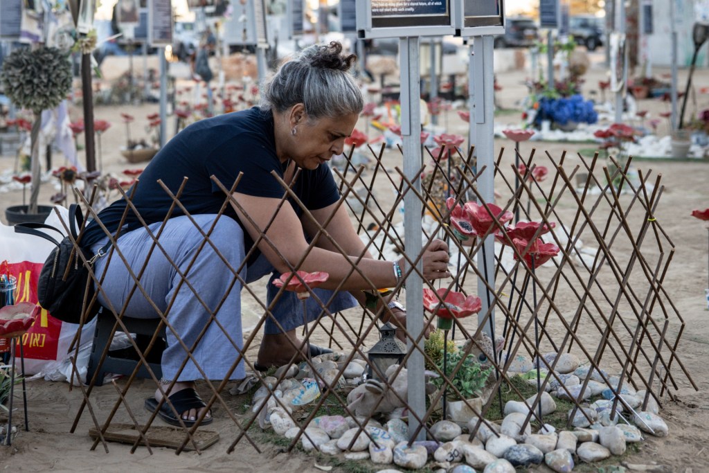 A woman cleans the memorial of a victim at the site of the Nova Festival to mark the 2nd anniversary of the Oct. 7 attacks on October 07, 2025 in Re'im, Israel. Various commemorations are taking place around Israel to mark the second anniversary of the Hamas-led attacks in Israel and the Gaza border area on October 7, 2023. During the attacks, 251 hostages were taken and around 1,200 people were killed, making it the deadliest attack in Israel's history. In response to the attacks, Israel launched a military campaign in Gaza, which has so far killed more than 67,000 people and displaced around 90% of the enclave's population of 2.1 million. (Photo by Chris McGrath/Getty Images)
