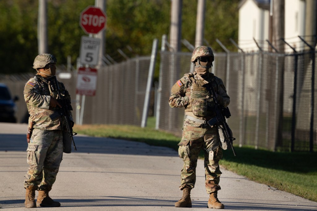 Members of the Texas National Guard stand guard at an army reserve training facility on October 07, 2025 in Elwood, Illinois. (Photo by Scott Olson/Getty Images)
