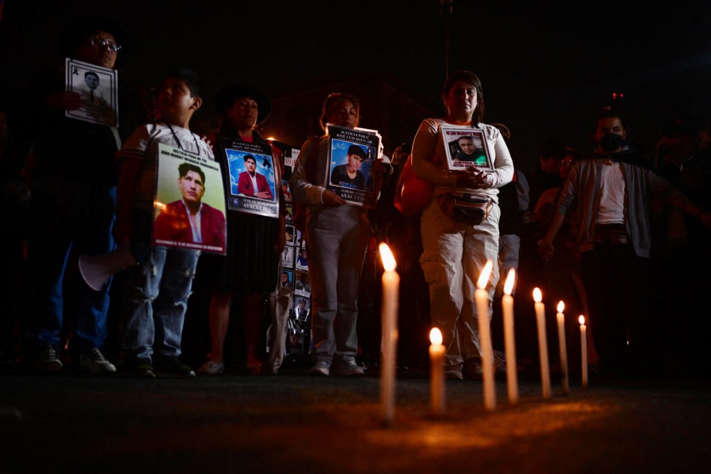 Peruvians light candles during a vigil for the victims of the anti-government protest after weeks of demonstrations over corruption and organized crime in Lima on October 26, 2025. On October 22, Peru's government deployed soldiers to the streets of Lima under a state of emergency declared following weeks of anti-government protests over corruption and organized crime. (Photo by ERNESTO BENAVIDES/AFP via Getty Images)