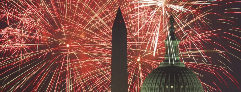 Fireworks explode over the National Mall as the US Capitol (R) and National Monument (Center) are seen in the foreground.