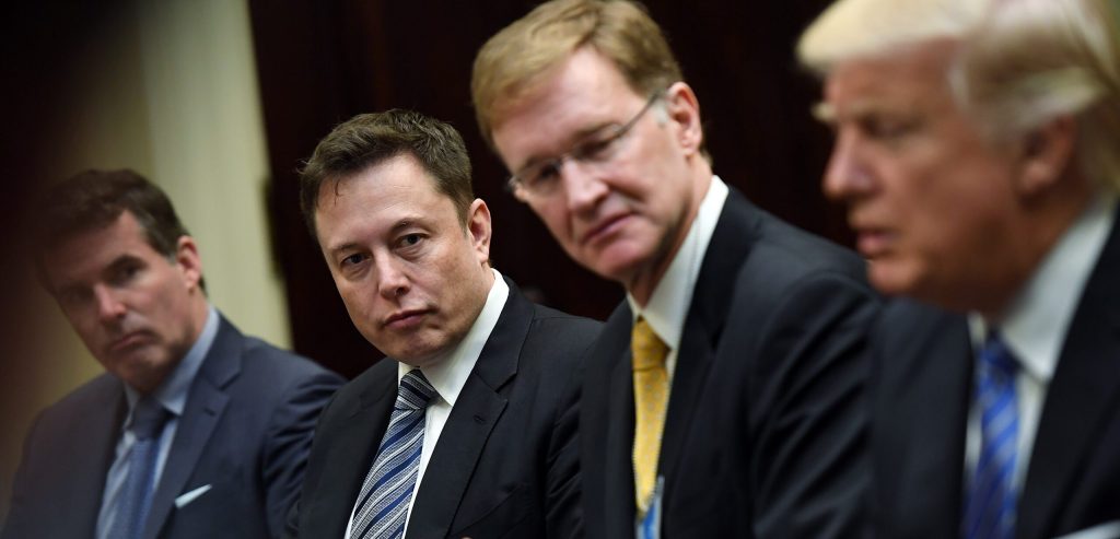 Elon Musk, left center, and Wendell P. Weeks, right center, listen to President Donald Trump, right, as he meets with business leaders at the White House on Monday January 23, 2017 in Washington, DC. (Photo by Matt McClain/The Washington Post via Getty Images)